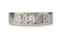 Lot 19 - DIAMOND SET BAND with a row of channel set...