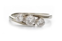 Lot 77 - DIAMOND THREE STONE RING set with a central...