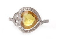 Lot 89 - YELLOW SAPPHIRE AND DIAMOND RING set with a...