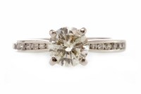 Lot 271 - PLATINUM DIAMOND SOLITAIRE RING with a four...