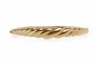 Lot 310 - NINE CARAT GOLD BANGLE of oval form, the top...