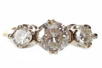 Lot 320 - DIAMOND THREE STONE RING set with a central...