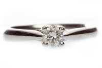 Lot 633 - PLATINUM DIAMOND SOLITAIRE RING with a four...