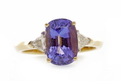 Lot 756 - TANZANITE AND DIAMOND RING set with a central...