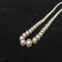 Lot 391 - PEARL NECKLACE formed by a single strand of...