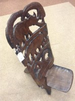 Lot 593 - 20TH CENTURY AFRICAN CARVED WOOD FOLDING CHAIR...