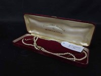 Lot 11 - CULTURED PEARL NECKLACE with a gold clasp,...