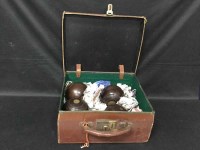 Lot 54 - FOUR LAWN BOWLS in a leather case