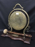 Lot 234 - BRASS TABLE GONG ON WOOD STAND together with a...