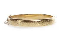 Lot 115 - NINE CARAT GOLD BANGLE the front section with...