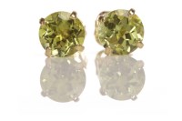 Lot 217 - PAIR OF PERIDOT EARRINGS each with a four claw...