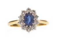 Lot 584 - BLUE GEM SET AND DIAMOND RING set with an oval...