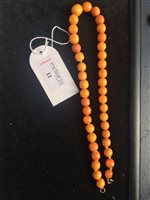 Lot 11 - TWO AMBER BEAD NECKLACES ALONG WITH A BRACELET AND A HAT PIN