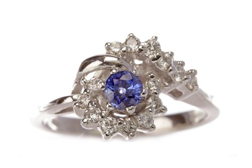 Lot 184 - A DIAMOND AND BLUE GEM SET RING