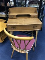 Lot 433 - AN ERCOL BLONDE OAK WRITING DESK AND A SPINDLE BACK CHAIR