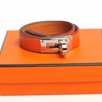 Lot 1669 - HERMES LEATHER BRACELET in orange leather, the...