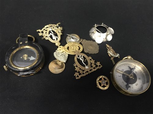Lot 298 - A FIRST WORLD WAR MILITARY COMPASS AND ANOTHER WITH A COLLECTION OF BADGES