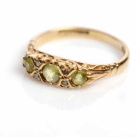 Lot 1708 - PERIDOT AND DIAMOND RING set with three round...