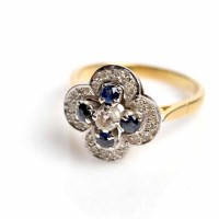 Lot 1715 - SAPPHIRE AND DIAMOND CLUSTER RING with a...