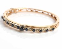 Lot 1721 - SAPPHIRE AND DIAMOND BANGLE set with eleven...