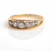 Lot 1731 - GRADUATED DIAMOND DRESS RING channel set with...
