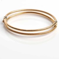 Lot 1755 - NINE CARAT GOLD BANGLE of oval form, formed by...