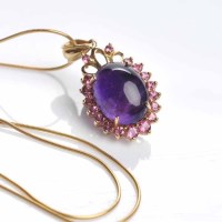 Lot 1834 - AMETHYST AND PINK SAPPHIRE PENDANT with a...