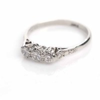 Lot 1854 - PLATINUM DIAMOND THREE STONE RING set with...