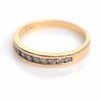 Lot 1864 - DIAMOND HALF ETERNITY RING channel set with...