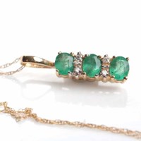 Lot 1888 - EMERALD AND DIAMOND PENDANT set with three...