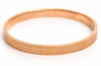 Lot 1930 - NINE CARAT GOLD BANGLE of circular form, with...