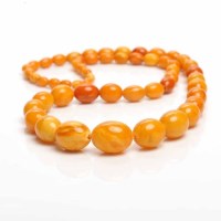 Lot 1941 - AMBER NECKLACE formed by graduated ovoid beads,...