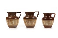 Lot 1871 - A LOT OF THREE DOULTON ‘EGYPTIAN REVIVAL’ CIDER JUGS
