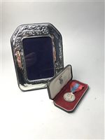 Lot 16 - AN IMPERIAL SERVICE MEDAL AND A SILVER PHOTOGRAPH FRAME
