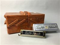 Lot 74 - A FAUX BAKELITE SEWING BOX AND A HARMONICA
