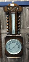 Lot 123 - AN EARLY 20TH CENTURY CARVED OAK BAROMETER