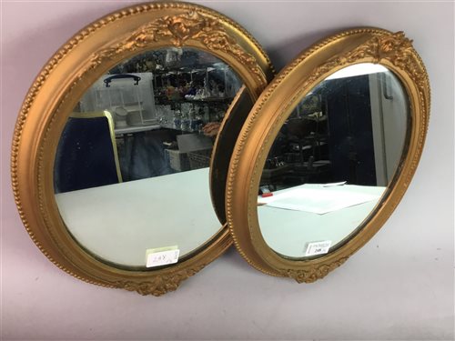Lot 248 - A PAIR OF GILT OVAL WALL MIRRORS AND ANOTHER