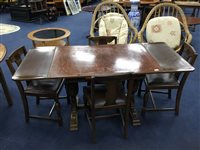 Lot 135 - AN OAK DRAW LEAF DINING TABLE AND FOUR CHAIRS