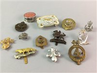 Lot 253 - A SILVER PILL BOX AND A GROUP OF BUCKLES AND BADGES