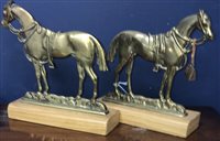 Lot 321 - A PAIR OF BRASS DOORSTOPS AND TWO CHRISTMAS TINS