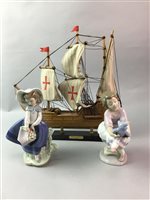 Lot 39 - A CERAMIC TABLE LAMP, TWO LLADRO FIGURES AND A MODEL OF A SHIP