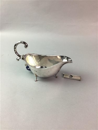 Lot 98 - A SILVER CIGAR CUTTER AND A SILVER GRAVY BOAT