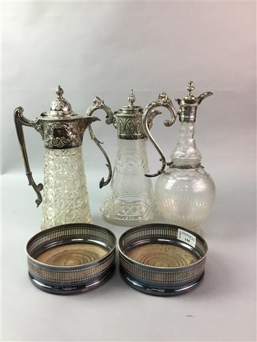 Lot 144 - A PAIR OF SILVER PLATED WINE SLIDES AND THREE CLARET JUGS