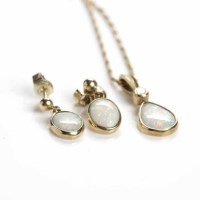 Lot 22 - OPAL AND DIAMOND PENDANT set with a single...