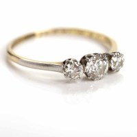 Lot 27 - MID-TWENTIETH CENTURY DIAMOND THREE STONE RING...