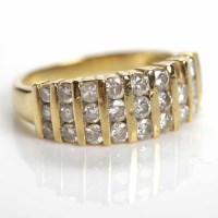 Lot 41 - DIAMOND DRESS RING with rows of channel set...