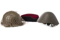 Lot 1766 - A POST WAR AMERICAN STYLE STEEL HELMET, AN EAST GERMAN HELMET AND ANOTHER