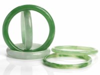 Lot 62 - FIVE JADEITE BANGLES all of green tone, all...