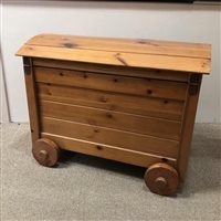 Lot 61 - A FREE STANDING CAKE STAND AND A PINE TOY CHEST