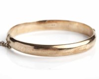 Lot 87 - NINE CARAT ROSE GOLD BANGLE engraved with a...